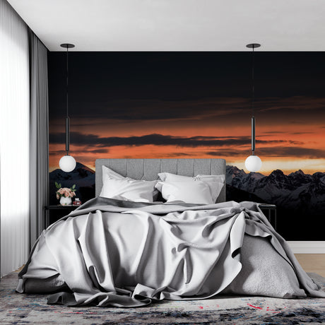 Mountain landscape wallpaper in modern living room showing sunset peaks above grey sofa