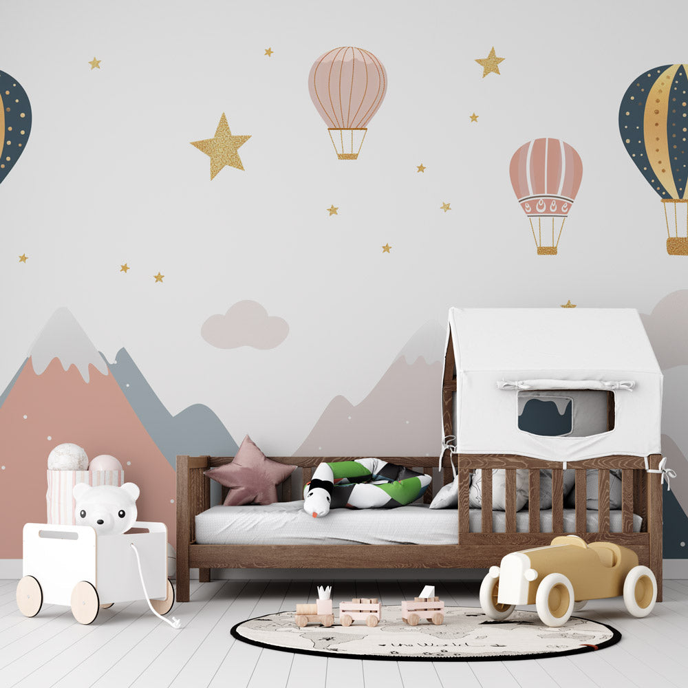 Mountain hot air balloon wallpaper creating a dreamy atmosphere in a modern nursery with white furniture