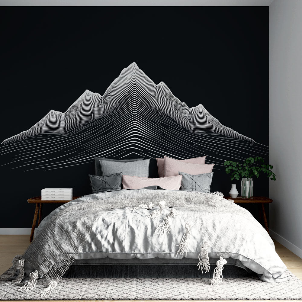 Modern mountain wallpaper with linear art design shown in a minimalist living room with black furniture and natural light