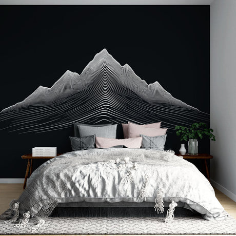 Modern mountain wallpaper with linear art design shown in a minimalist living room with black furniture and natural light