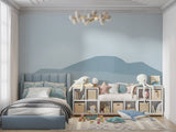 Mountain mural wallpaper creating a peaceful atmosphere in a modern living room with minimal furniture