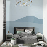 Blue mountain wallpaper in a bright bedroom setting with natural light