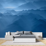 Mountain range wallpaper creating depth in modern living room with grey sofa and natural light