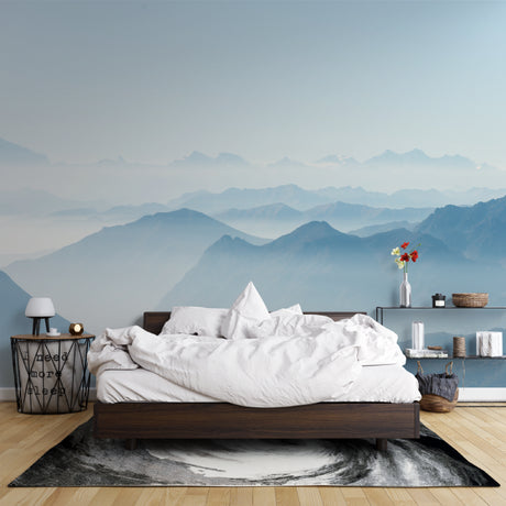 Mountain mural wallpaper creating depth in modern living room with grey sofa and natural light