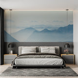 Misty mountain mural creating calm atmosphere in meditation room with floor cushions