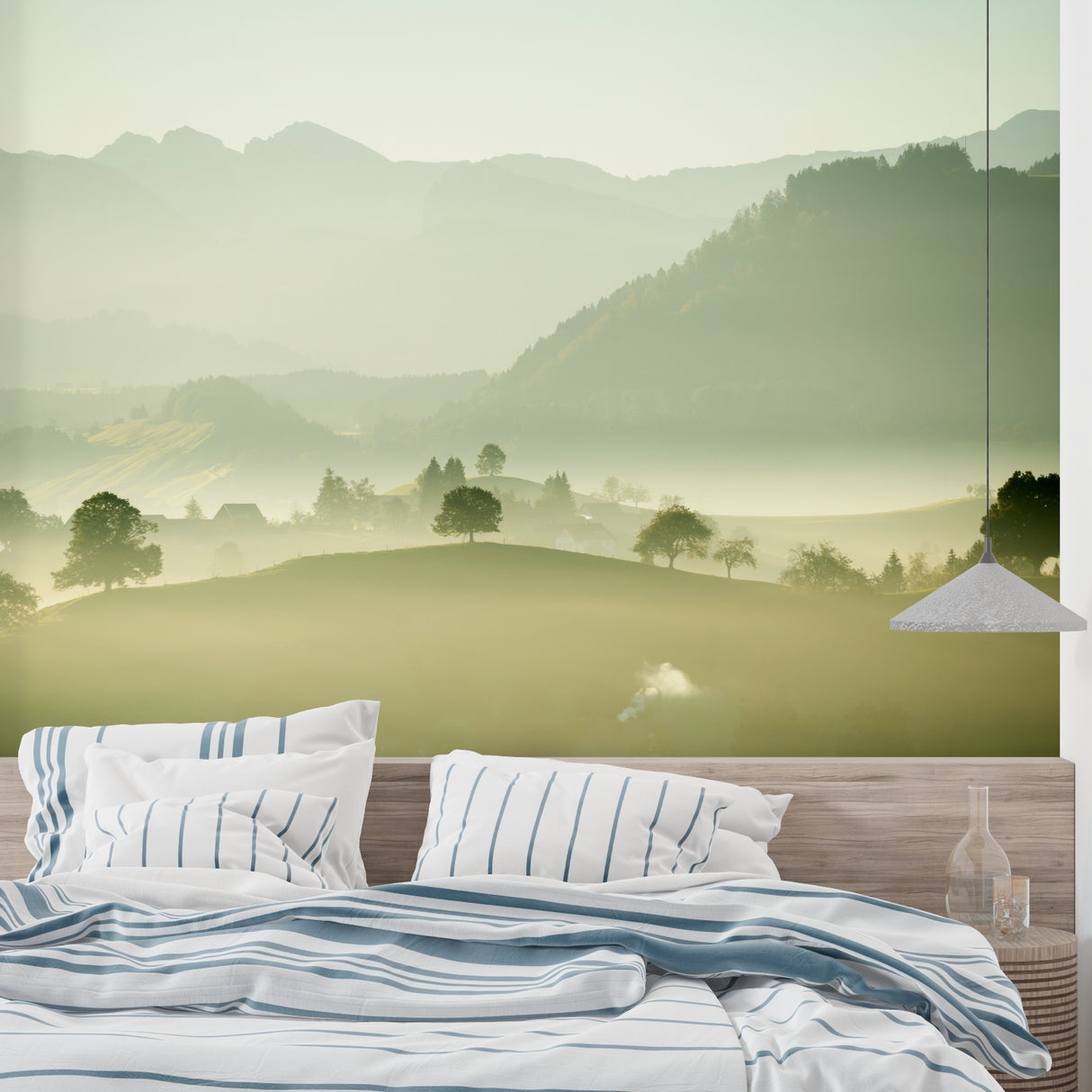 Mountain landscape wallpaper creating depth in a modern living room with grey sofa and natural light