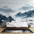 Mountain mural wallpaper creating depth in modern living room with gray sofa and natural light