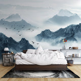 Mountain mural wallpaper creating depth in modern living room with gray sofa and natural light