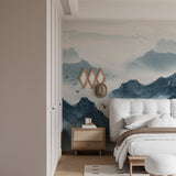 Mountain peak mural creating focal point in dining room with natural decor