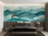 Teal mountain wallpaper in cozy bedroom setting with natural light