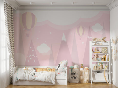 Pink mountain wallpaper with hot air balloons creating a magical atmosphere in a bright nursery room