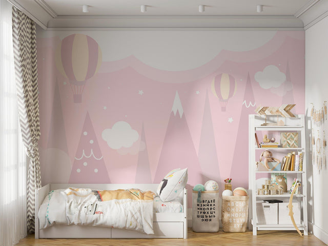 Pink mountain wallpaper with hot air balloons creating a magical atmosphere in a bright nursery room