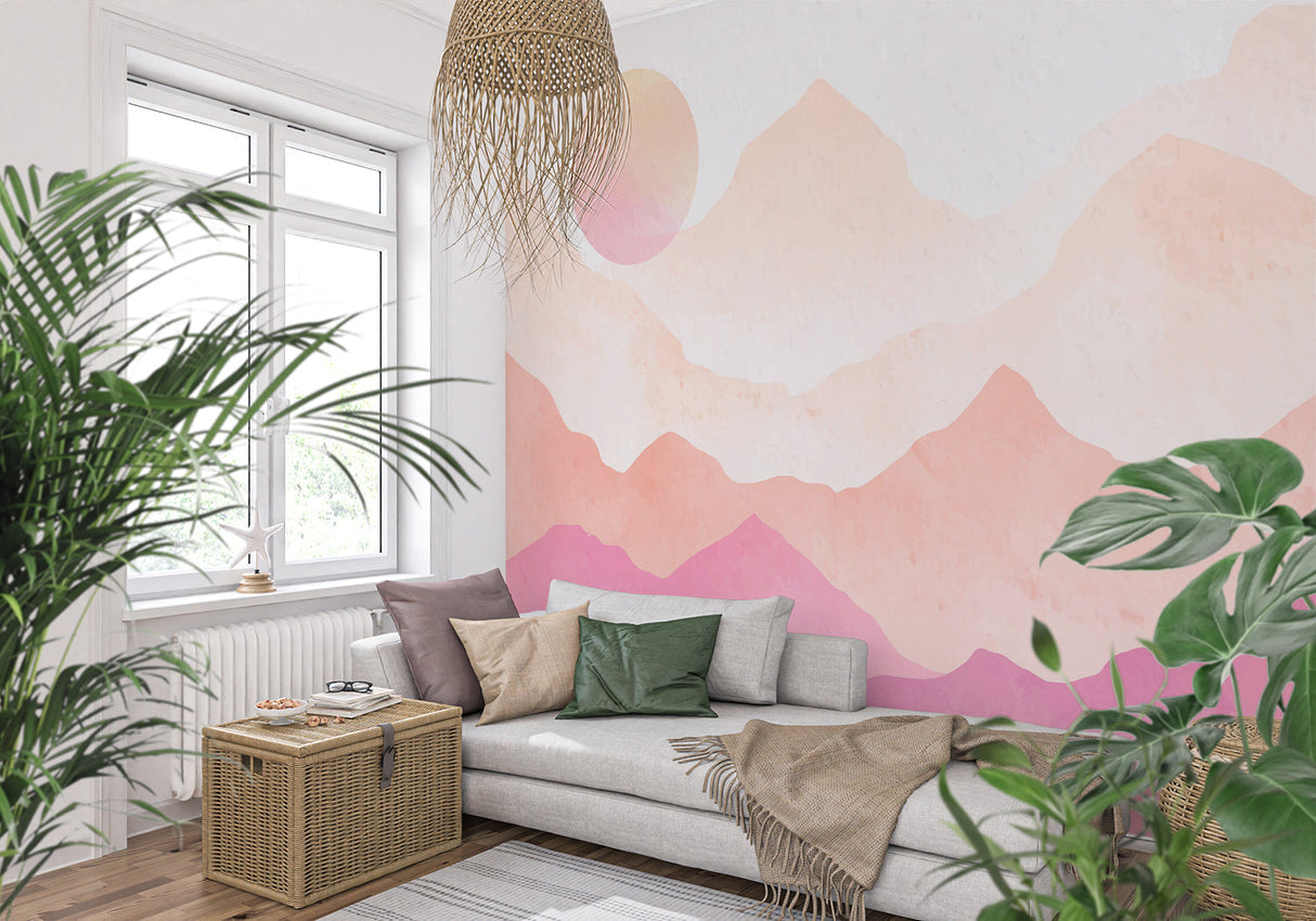 Watercolor mountain mural in a cozy bedroom setting with soft pink sunset tones
