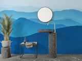 Mountain wall mural in modern living room showing blue gradient peaks creating depth