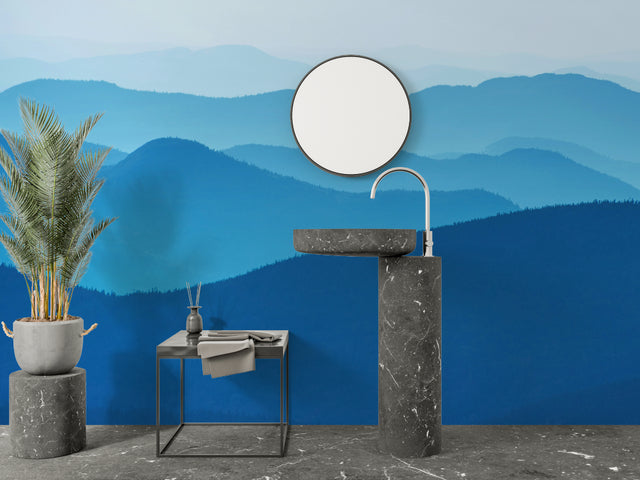 Mountain wall mural in modern living room showing blue gradient peaks creating depth