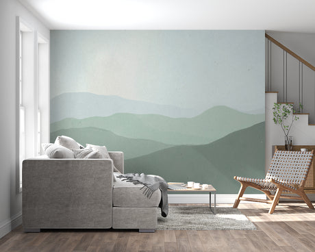 Mountain landscape wallpaper creating depth in modern living room with grey sofa and natural light