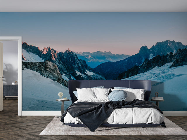 Mountain landscape wallpaper in modern living room with grey sofa and natural light