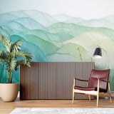 Mountain landscape wallpaper in modern living room creating serene atmosphere with soft green gradient tones
