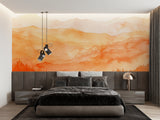 Mountain sunset mural wallpaper in modern living room showing orange and beige tones