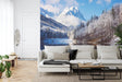Mountain landscape wallpaper creating depth in modern living room with white sofa and natural decor