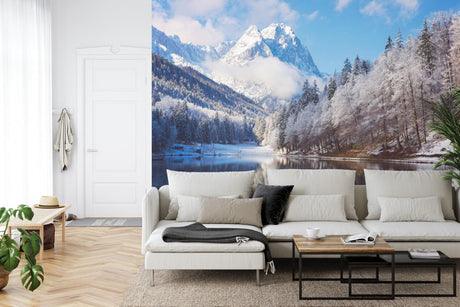 Mountain landscape wallpaper creating depth in modern living room with white sofa and natural decor