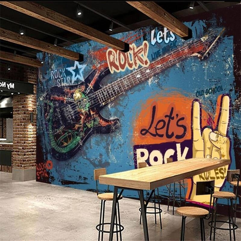 Rock and roll graffiti wallpaper creating urban atmosphere in a modern teen bedroom with blue and orange tones