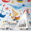Nautical wallpaper bringing ocean fun to a bright kids bedroom, with red and blue sailing boats dancing on waves