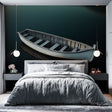 Nautical wall mural with wooden boat creates a stunning focal point in a modern living room with minimal furniture
