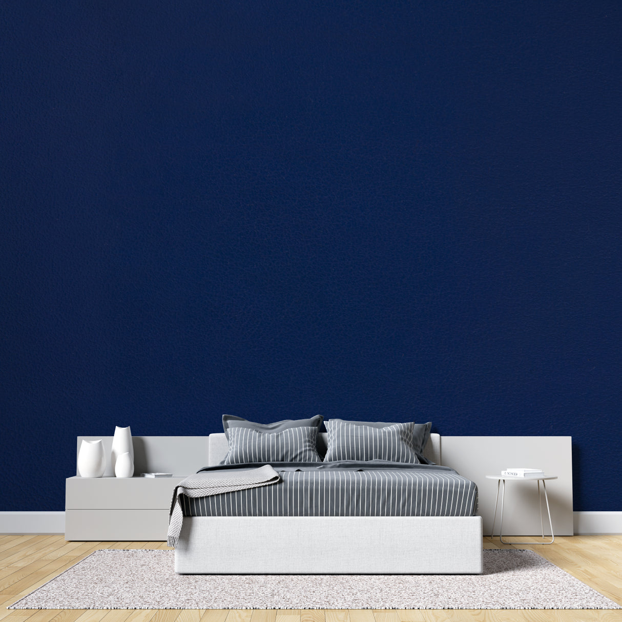 Master bedroom with navy blue accent wall creating a cozy, peaceful atmosphere