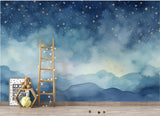 Celestial wall mural bringing magic to a nursery, with soft blue clouds and twinkling golden stars