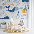 Ocean themed wallpaper brings underwater adventure to a bright nursery with playful marine animals