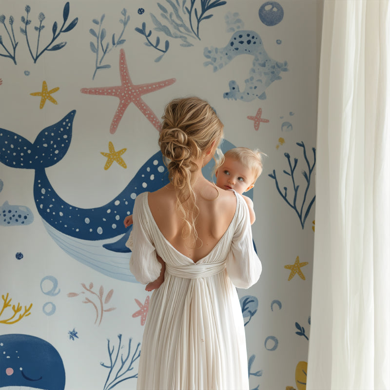 Playroom showing ocean mural wallpaper with cute sea creatures in soft colors