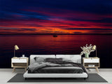 Ocean sunset mural wallpaper creating a cozy atmosphere in a modern living room with floor-to-ceiling windows