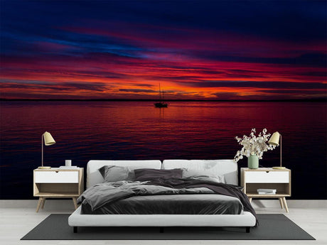 Ocean sunset mural wallpaper creating a cozy atmosphere in a modern living room with floor-to-ceiling windows