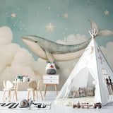 Whale nursery wallpaper creating a magical atmosphere in a modern nursery with soft mint walls and wooden furniture