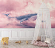 Pink whale wallpaper creating a dreamy atmosphere in a modern nursery with white furniture