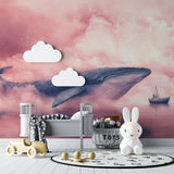 Pink ocean wallpaper with whale creating magical atmosphere in girl's bedroom