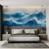 Ocean wave wallpaper creating depth in modern living room with white furniture