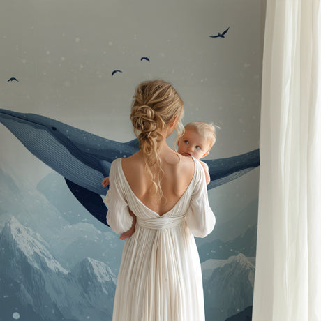 Whale nursery wallpaper creating a peaceful atmosphere in a modern nursery with white furniture