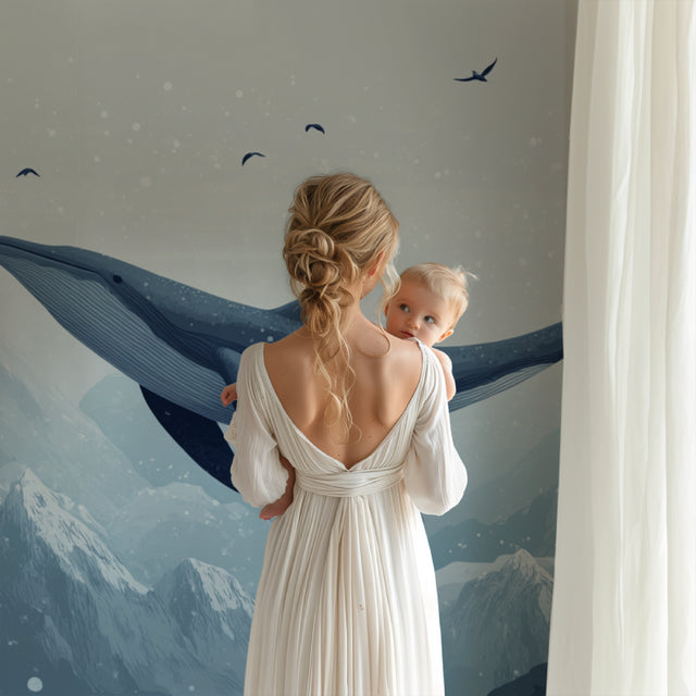 Whale nursery wallpaper creating a peaceful atmosphere in a modern nursery with white furniture