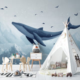 Flying whale wallpaper making a statement in a cozy reading nook