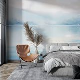 Watercolor ocean mural bringing serenity to a minimal bedroom space