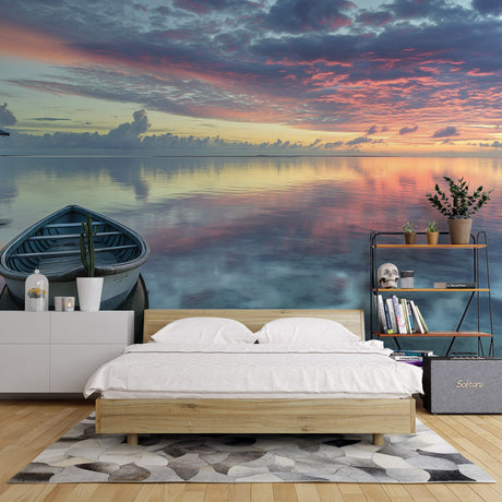 Ocean sunset mural wallpaper creating depth in modern living room, pink and orange hues reflecting on walls