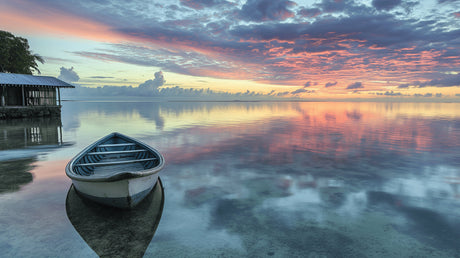 Seascape wallpaper with wooden boat in cozy bedroom setting, warm sunset colors