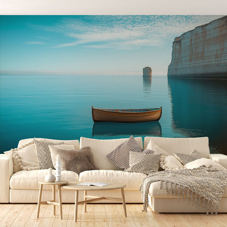 Ocean landscape wallpaper creating a serene atmosphere in a modern living room with white furniture and natural light