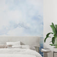 Ocean landscape wallpaper creating a serene atmosphere in a modern living room with natural light
