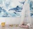 Blue whale wallpaper mural styled in modern nursery with white furniture and soft lighting