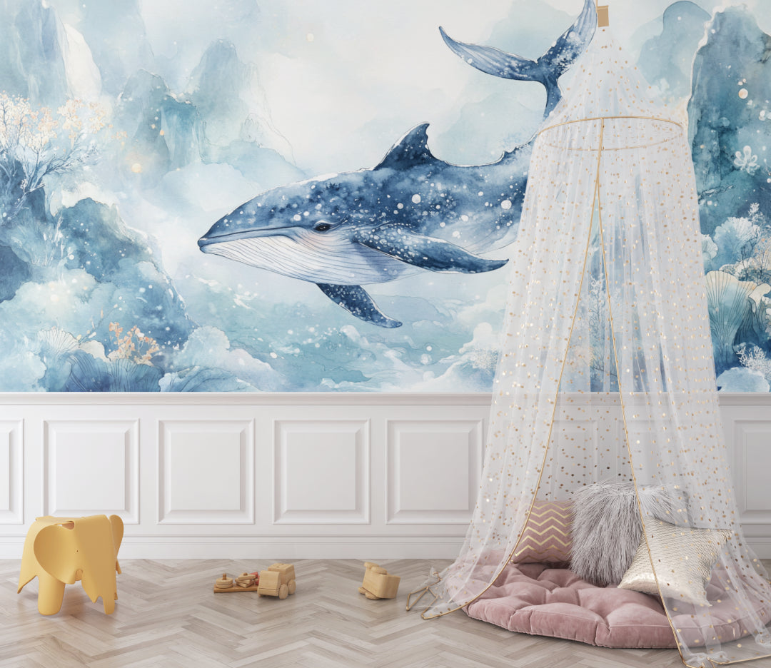 Blue whale wallpaper mural styled in modern nursery with white furniture and soft lighting