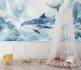 Blue whale wallpaper mural styled in modern nursery with white furniture and soft lighting