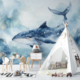 Whale mural wallpaper showcased in cozy reading nook with natural lighting